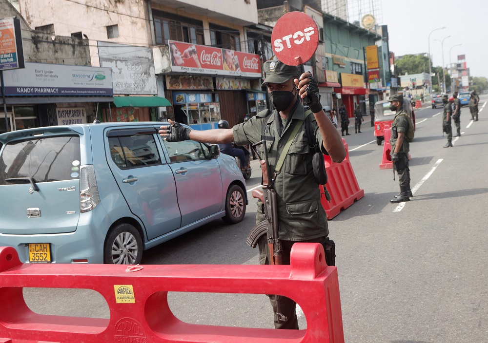An army member stops vehicles at a check point on the main road after the curfew was extended for another extra day amid the country's economic crisis, in Colombo, Sri Lanka May 11, 2022. u00e2u20acu2022 Reuters pic