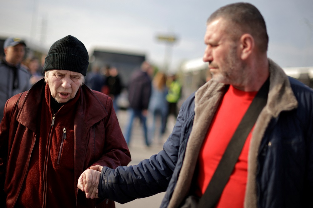 A Ukrainian woman evacuee from Mariupol walks with her son after arriving at a registration centre for internally displaced people in Zaporizhzhia, Ukraine May 3, 2022. u00e2u20acu2022 Reuters pic