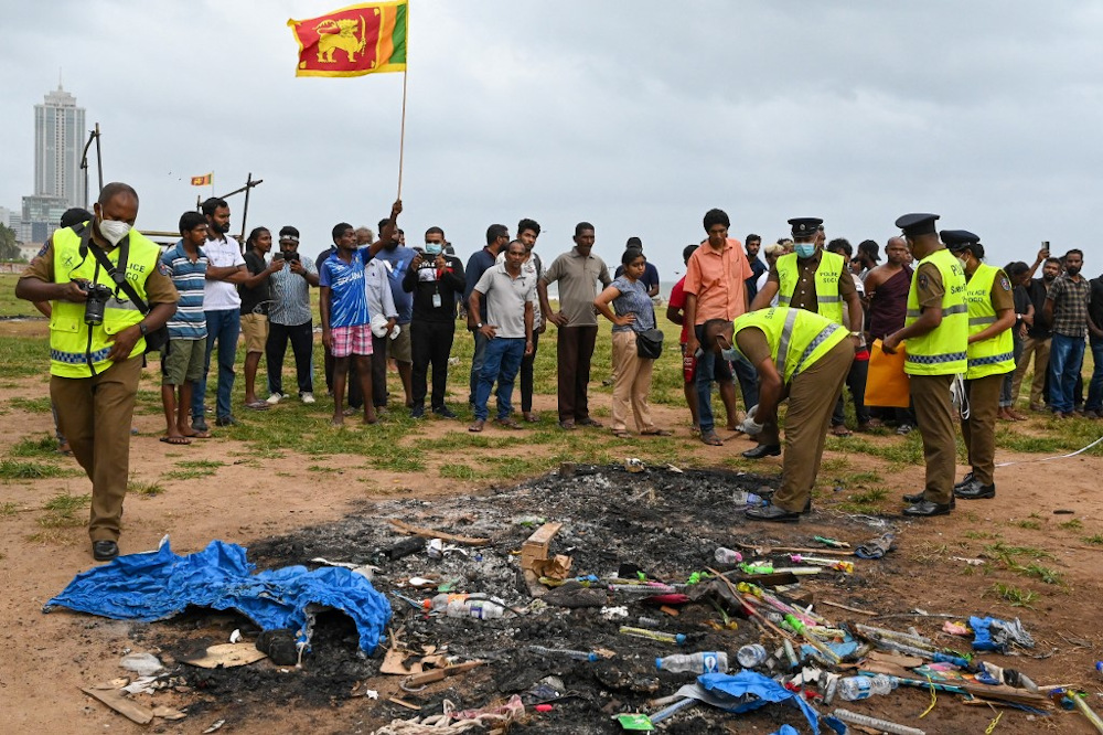 Police conduct investigations at a spot, a day after clashes between government supporters and demonstrators in Colombo on May 10, 2022. u00e2u20acu201d AFP pic