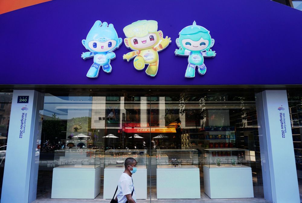 A person wearing a protective mask walks past a souvenir store for the 19th Asian Games 2022 in Hangzhou May 6, 2022. u00e2u20acu201d Reuters pic