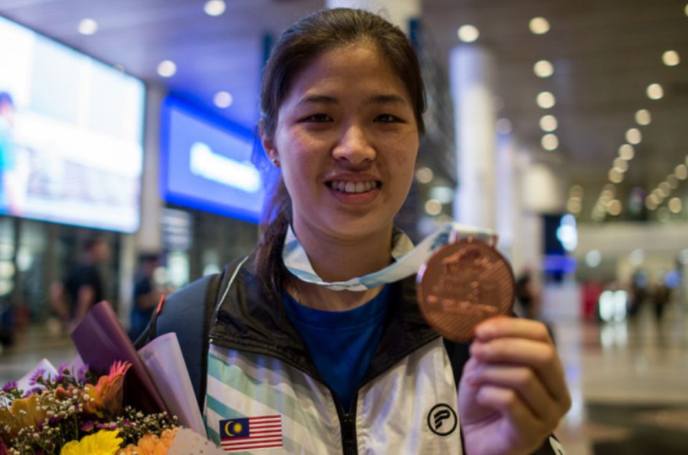 File picture shows National womenu00e2u20acu2122s singles badminton player Boon Wei Ying showing off the bronze medal she won at the World Deaf Badminton Championships in Taipei, upon arrival at Kuala Lumpur International Airport, July 23, 2019. u00e2u20acu201d Bernama pic