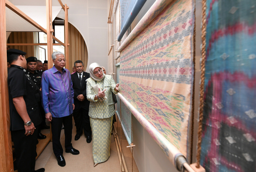 Raja Permaisuri Agong Tunku Hajah Azizah Aminah Maimunah Iskandariah (centre) with Prime Minister Datuk Seri Ismail Sabri Yaakob visiting Tenun Pahang Diraja during London Craft Week at the Malaysian High Commission building in Belgrave Square, May 10, 20