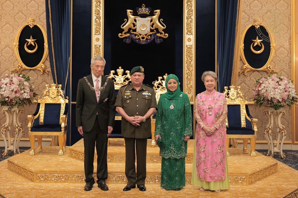 Sultan Ibrahim Sultan Iskandar and his consort Permaisuri of Johor Raja Zarith Sofiah Sultan Idris Shah flanked by Singapore PM Lee Hsien Loong and his wife Ho Ching at the Istana Besar in Johor Baru May 6, 2022. u00e2u20acu201d Picture courtesy of Johor Royal Press 