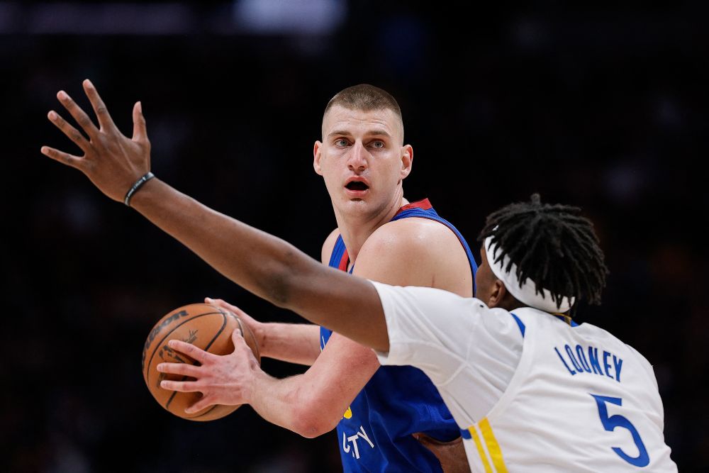 Denver Nuggets centre Nikola Jokic (15) controls the ball as Golden State Warriors centre Kevon Looney (5) guards during the 2022 NBA playoffs at Ball Arena in Denver April 21, 2022. u00e2u20acu201d Reuters picnn