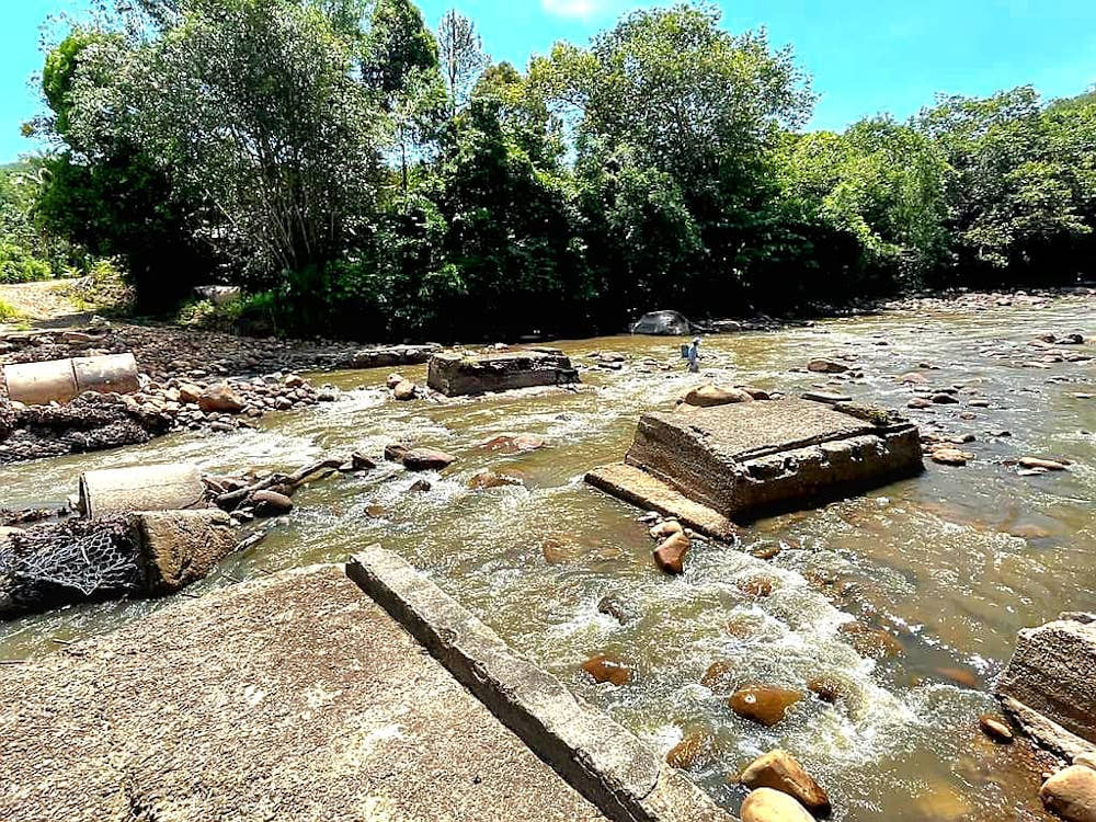 The damaged concrete bridge at Kg Mendulong. u00e2u20acu201d Borneo Post pic