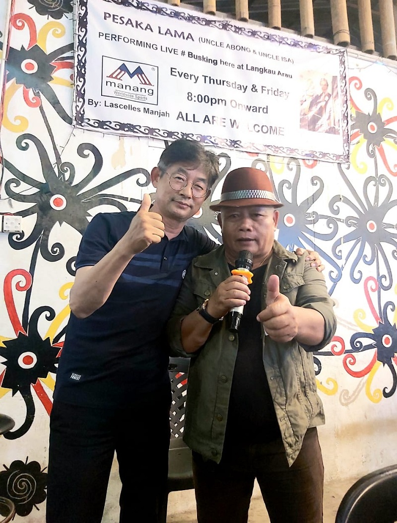 Isa (right) is joined by a Korean known as Mr Yoo who joined him to sing the Iban classic Bekikis Bulu Betis. Mr Yoo was at a rumah asap where Isau00e2u20acu2122s band Pesaka Lama was performing. u00e2u20acu201d Borneo Post Online pic