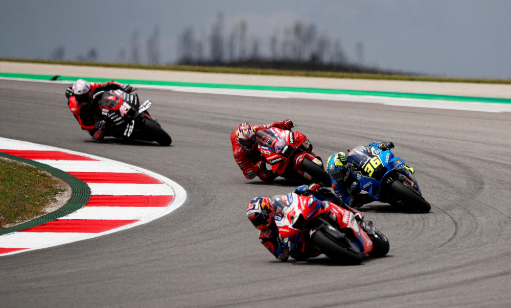 Pramac Racingu00e2u20acu2122s Johann Zarco, Team Suzuki Ecstaru00e2u20acu2122s Joan Mir and Ducati Lenovou00e2u20acu2122s Jack Miller in action during the MotoGP race at the Portuguese Grand Prix, Algarve International Circuit, Portimao, Portugal, April 24, 2022. u00e2u20acu201d Reuters picnn