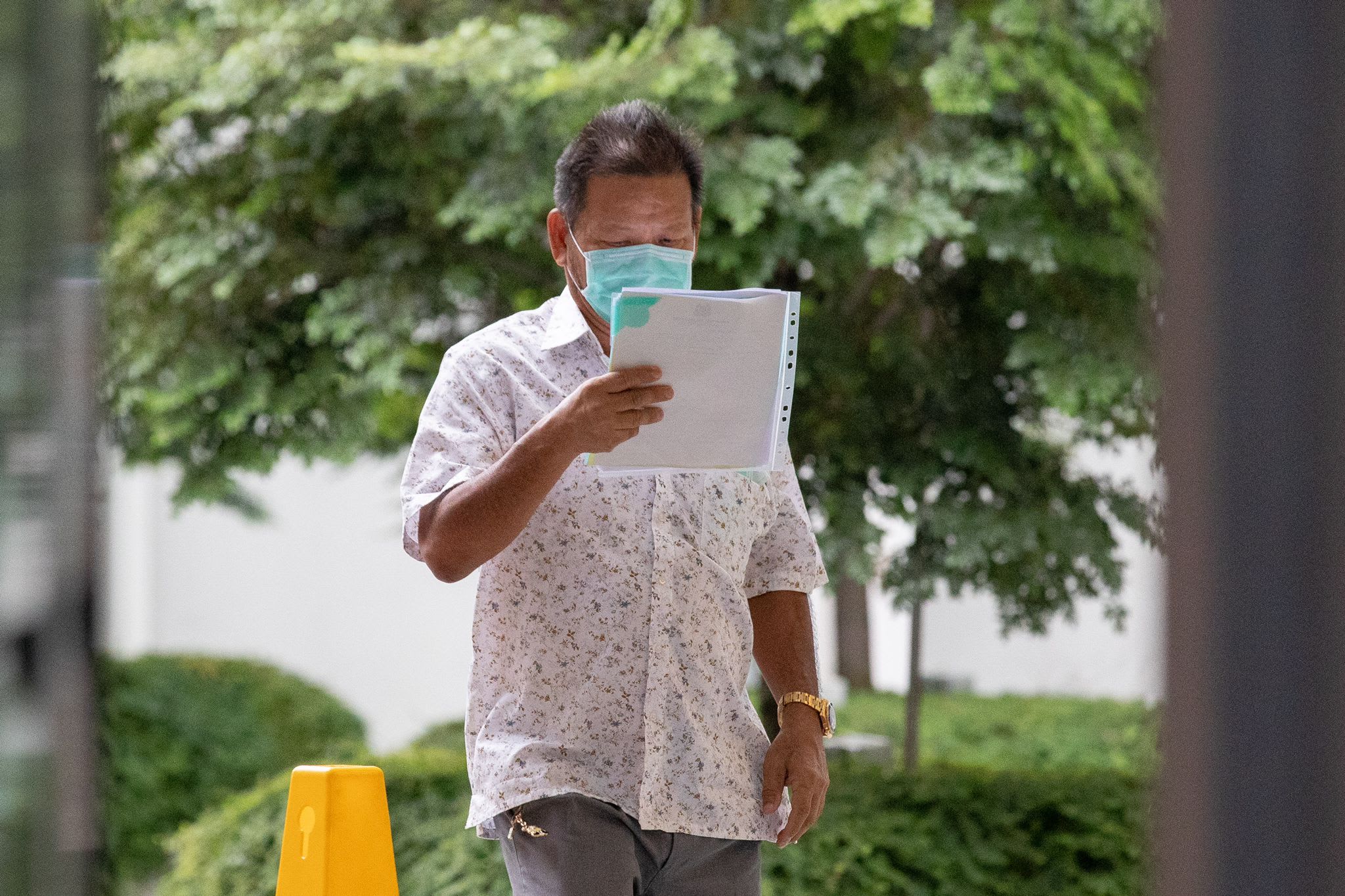 Neo Hong Chye, 61, arrives at the State Courts on May 11, 2022. u00e2u20acu2022 TODAY pic