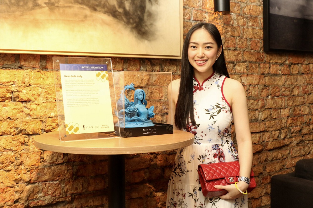Yap poses with the 8sian x Royal Selangor physical Jade Lady Pewter piece. ― Picture courtesy of 8sian