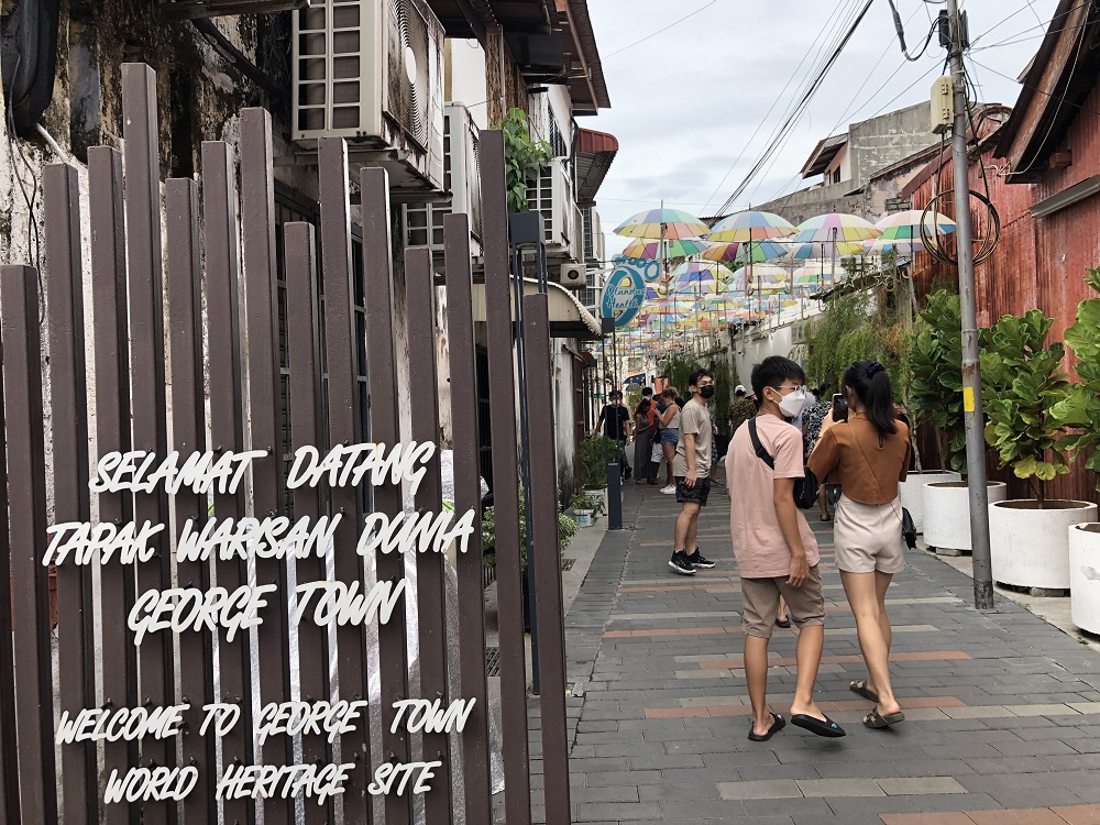 Visitors at one of the backlanes in inner George Town. ― Picture by Opalyn Mok