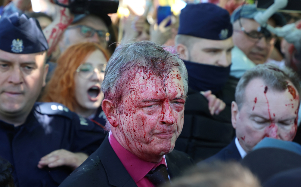 Russiau00e2u20acu2122s ambassador to Poland Sergey Andreev is covered in red substance thrown by protesters as he came to celebrate Victory Day at the Soviet Military Cemetery in Warsaw May 9, 2022. u00e2u20acu201d Slawomir Kaminski/Agencja Wyborcza.pl pic via Reuters 