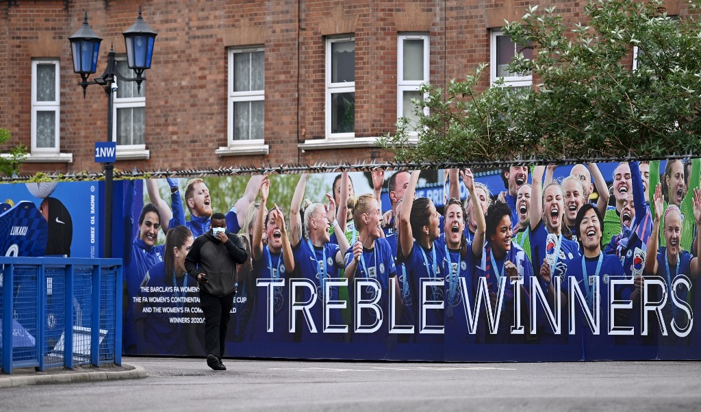 A pedestrian passes a sign at Stamford Bridge ahead of the English Premier League match between Chelsea and Wolverhampton Wanderers, in London on May 7, 2022. u00e2u20acu201d AFP pic