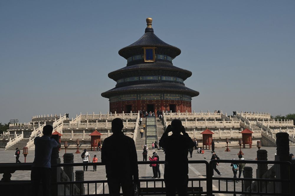 People walk inside the Temple of Heaven in Beijing during the Labour Day holidays on May 2, 2022. u00e2u20acu201d AFP pic