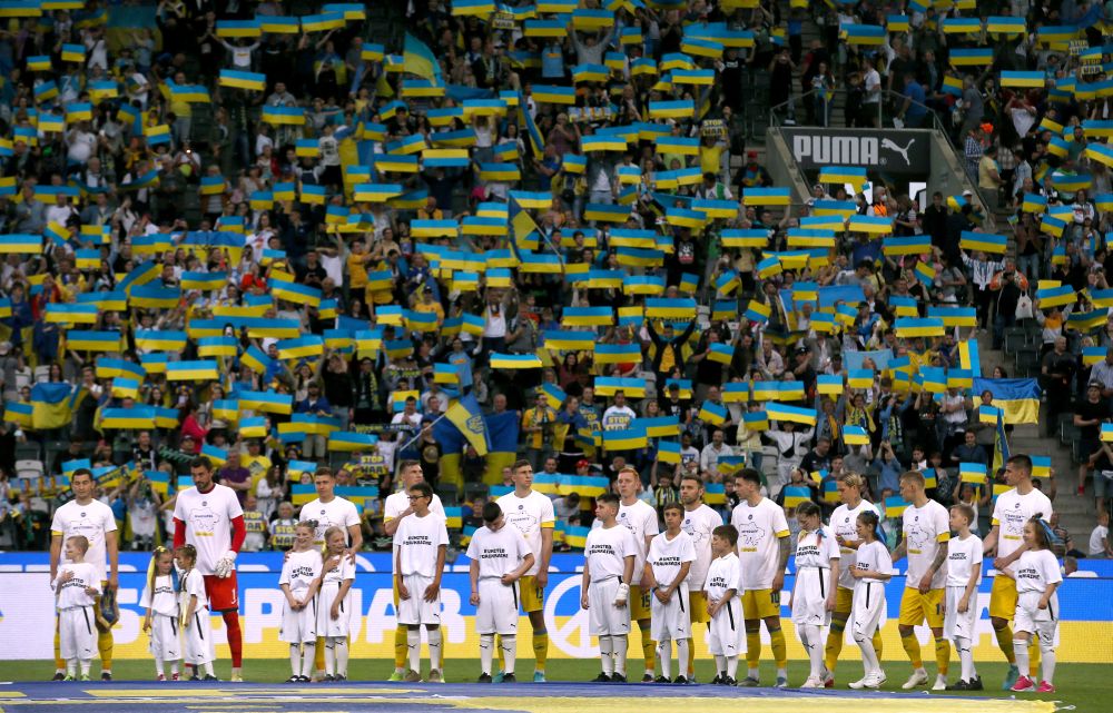 Ukraine players line up with young mascots before the friendly match against Borussia Moenchengladbach at Borussia-Park, Moenchengladbach May 11, 2022. u00e2u20acu201d Reuters pic