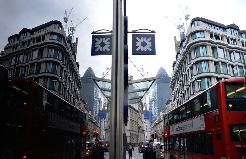 A logo from a Royal Bank of Scotland (RBS) branch is seen reflected in a window in the City of London March 6, 2013. u00e2u20acu201d Reuters pic