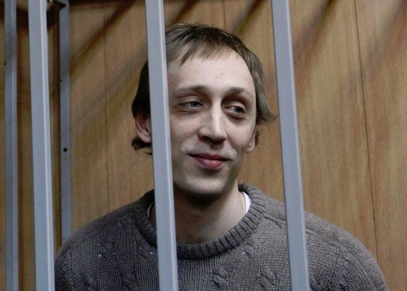 Dancer Pavel Dmitrichenko looks out from the defendant's holding cell during a hearing in Moscow October 22, 2013. u00e2u20acu201d Reuters pic