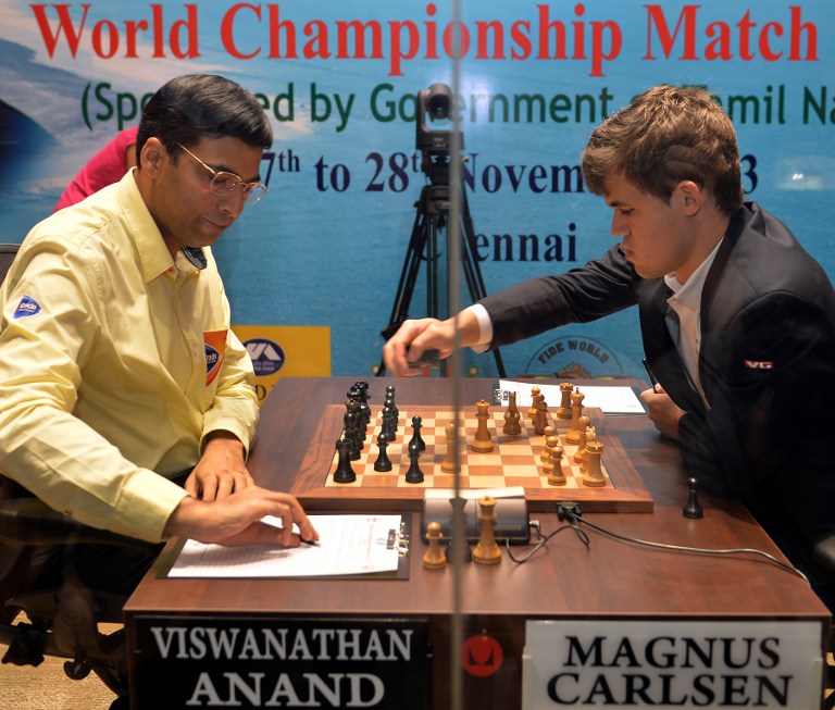 India's Viswanathan Anand (left) and Norway's Magnus Carlsen compete in their 10th championship chess match in Chennai on November 22, 2013. u00e2u20acu201d  AFP pic