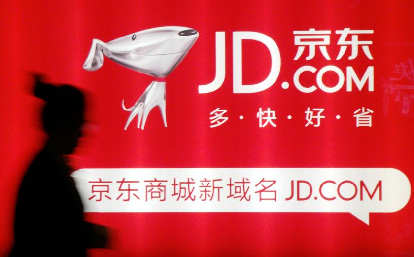 A woman walks past a advertisement board of Jingdong Mall (JD.com) in Nanjing, Jiangsu province in this May 7, 2013 file photo. u00e2u20acu201d Reuters pic