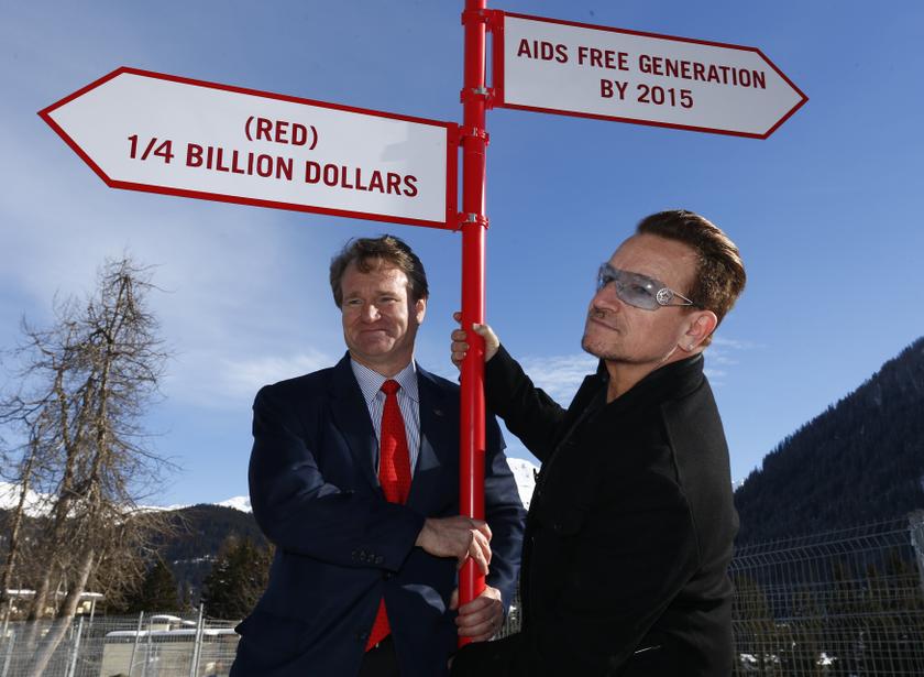Bono, singer and co-founder of (RED), poses with Brian Moynihan (left), CEO of Bank of America, in front of a signpost during a photocall at the World Economic Forum (WEF) in Davos January 24, 2014. u00e2u20acu201d Reuters pic