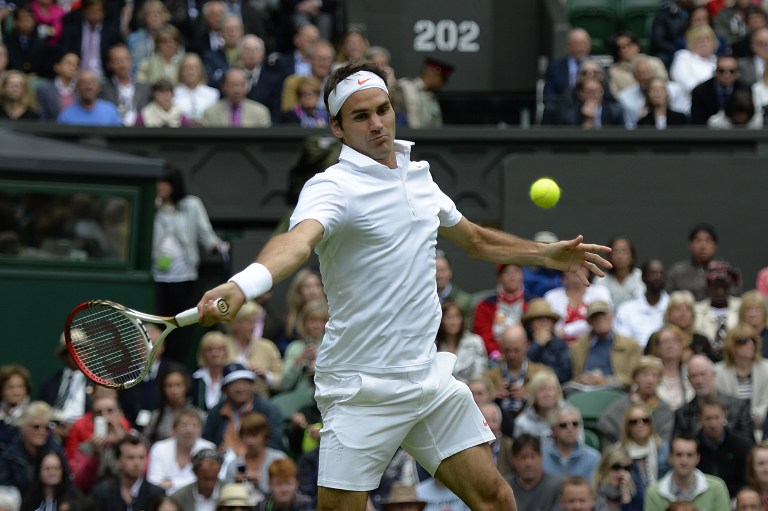 Switzerland's Roger Federer returns against Romania's Victor Hanescu during their men's first round match on day one of the 2013 Wimbledon Championships tennis tournament London, on June 24, 2013. u00e2u20acu201d AFP pic