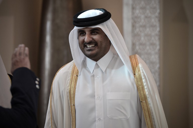 A file photo shows Qatari Crown Prince Sheikh Tamim bin Hamad al-Thani smiling as he arrives in the Bahraini capital of Manama, A December 24, 2012. u00e2u20acu201d AFP pic
