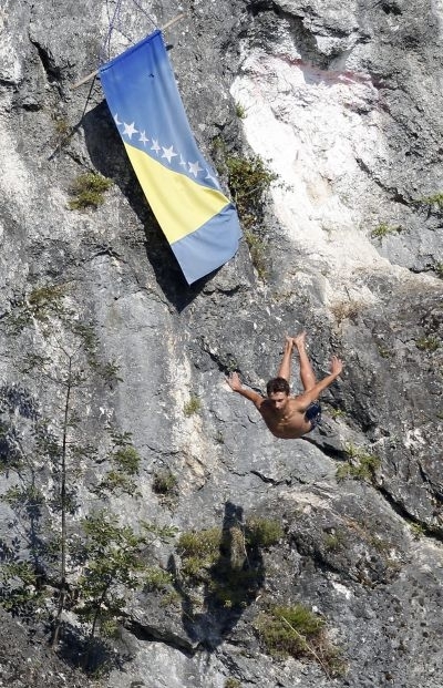 A Bosnian man dives into the river Neretva, on August 17, 2013, during the 'Jump in the pot,' a cliff diving competition attracting every August the most adventurous divers of the Balkans. — AFP-Relaxnews pic
