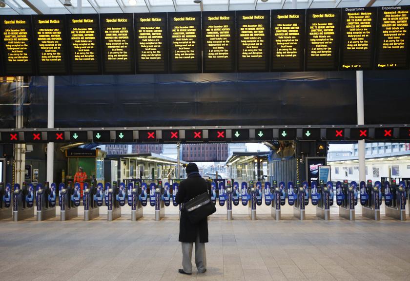 A man stands alone at London Bridge Station after numerous trains were cancelled due to storms in London.Disrupted transport networks and power cuts wreaked havoc in Britain and France yesterday, one of the busiest travel and shopping days of the year jus