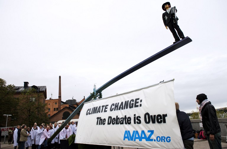 Activists gather outside the UN's IPCC with a giant 12 metre seesaw to give a visual image of the IPCC report's finding that there is 95 per cent scientific certainty that humans cause climate change, on September 27, 2013 in Stockholm. u00e2u20acu201d AFP pic