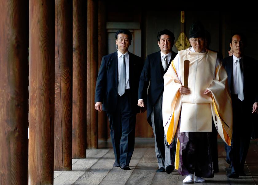 Japan's Prime Minister Shinzo Abe (2nd left) is led by a Shinto priest as he visits Yasukuni shrine in Tokyo December 26, 2013. Abe's visit has angered China, with Chinese papers denouncing the visit as paying homage to 'devils'. u00e2u20acu201d Reuters pic
