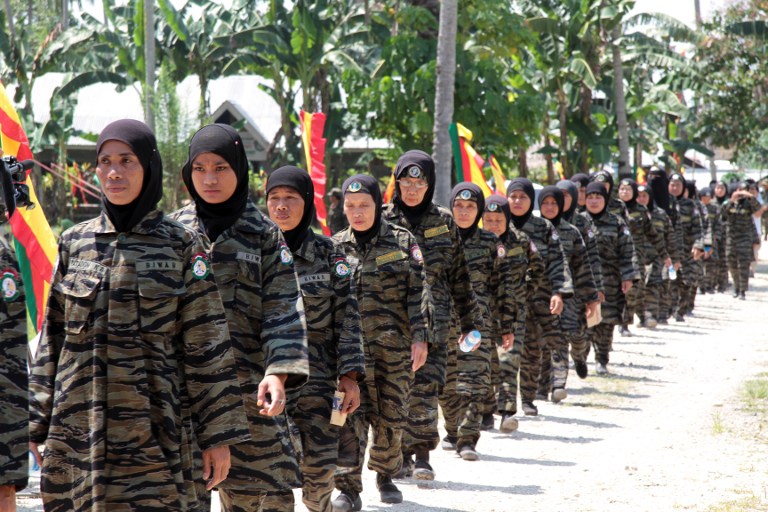 Women members of the Moro Islamic Liberation Front (MILF) marching during a celebration inside camp Darapanan in Sultan Kudarat town, on the southern island of Mindanao, October 15, 2012. u00e2u20acu201d AFP pic