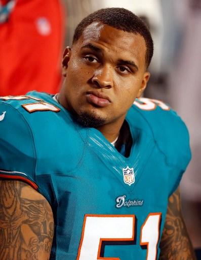 Center Mike Pouncey of the Miami Dolphins watches his team from the bench in this file photo on August 10, 2012 in Miami Gardens, Florida. — AFP pic