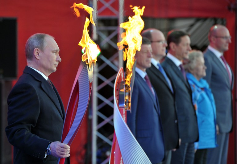 A file picture taken in Moscow on October 6, 2013, shows Russia's President Vladimir Putin holding a torch during a ceremony to mark the start of the Sochi 2014 Winter Olympic torch relay across Russia. u00e2u20acu201d AFP pic