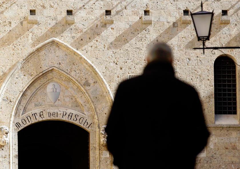 A man walks towards the main entrance of the Monte dei Paschi bank headquarters in Siena in this March 13, 2012 file photograph. u00e2u20acu201d Reuters pic
