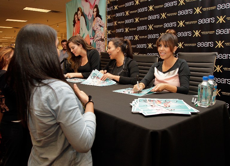 Khloe Kardashian Odom, Kim Kardashian and Kourtney Kardashian sign autographs for fans during a Sears In-Store Appearance For Kardashian Kollection at Willowbrook Mall on May 4, 2013 in Houston, Texas. u00e2u20acu201d AFP pic