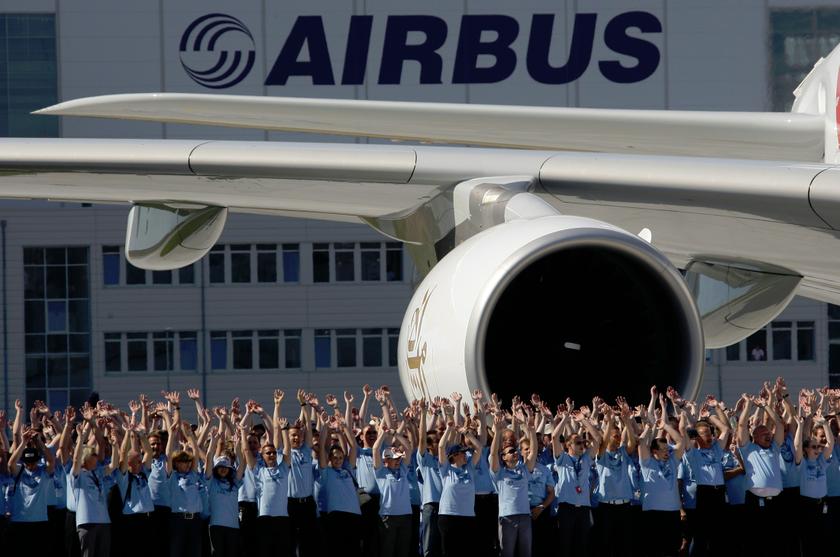 File photo of Airbus employees posing next to an aircraft during a hand-over ceremony in Hamburg, July 28, 2008. u00e2u20acu201d Reuters pic