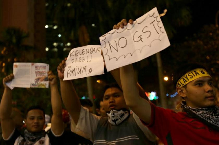Protestors hold up placards denouncing the rise in prices, during a rally in Kuala Lumpur, 31 December 2013.
