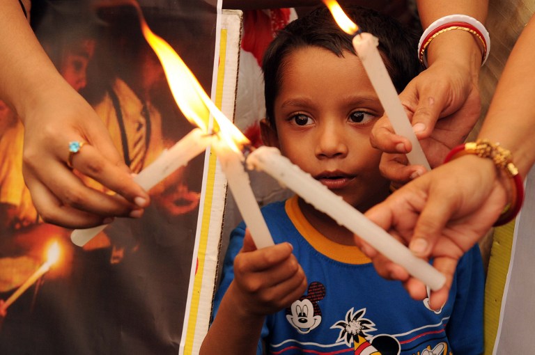 Social activists light candles as they walk during a silent protest rally following the gangrape and murder of a 20-year-old college student in Barasat, in Kolkata on June 17, 2013. u00e2u20acu201d AFP pic