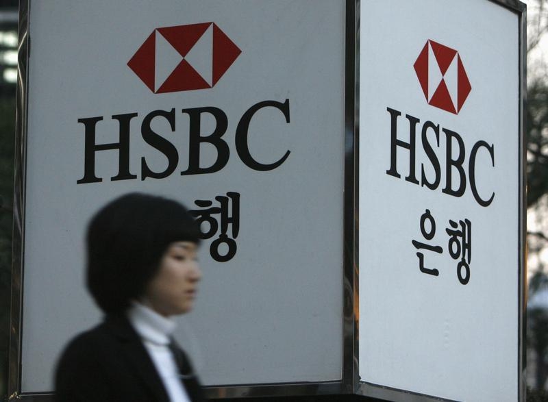 A woman walks past a HSBC logo at a branch office in Seoul March 5, 2008. u00e2u20acu201d Reuters pic