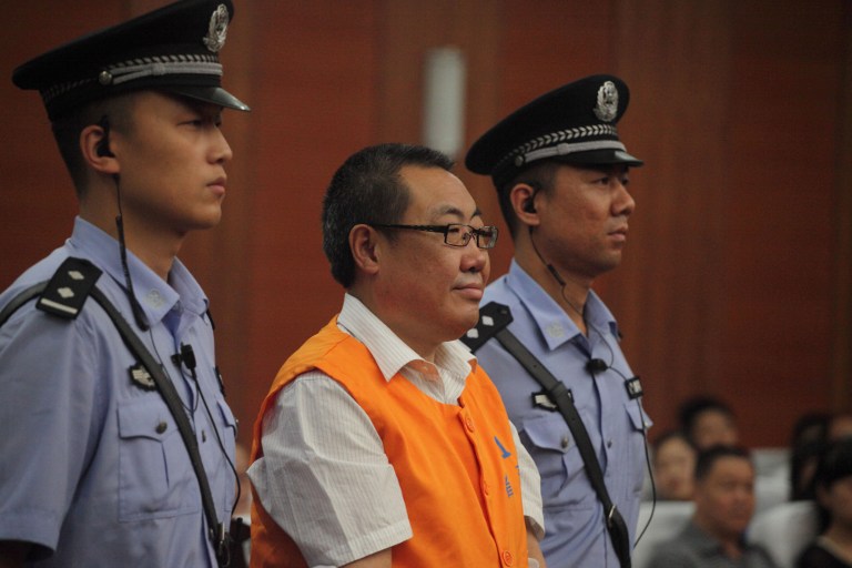 Yang Dacai (centre), a Chinese official branded 'Brother Watch' because of his expensive taste in timepieces, stands in the courtroom in the Intermediate people's court of Xian, northwest China's Shaanxi province on September 5, 2013. u00e2u20acu201d AFP pic