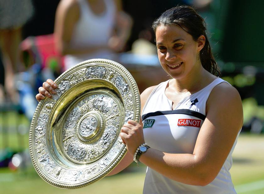 Marion Bartoli of France holds her trophy, the Venus Rosewater Dish, after defeating Sabine Lisicki of Germany in their women's singles final tennis match at the Wimbledon Tennis Championships, in London July 6, 2013. u00e2u20acu201d Reuters pic