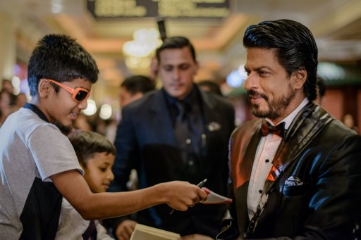 Indian Bollywood actor Shah Rukh Khan signs autographs during the14th International Indian Film Academy (IIFA) in Macau on July 6, 2013. u00e2u20acu201d AFP pic