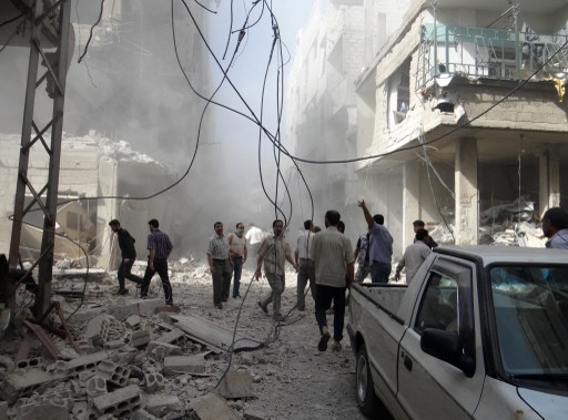 A handout picture released by the Syrian opposition-run Shaam News Network shows Syrians inspecting the damage following an air strike in Arbeen in the suburbs of Damascus on July 6, 2013.