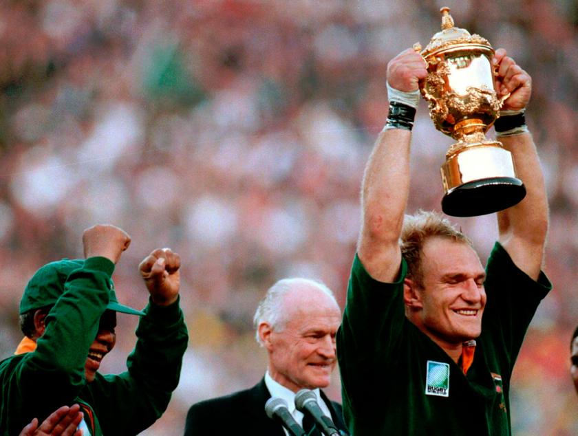 South African President Nelson Mandela raises his arms in jubilation as Springbok captain Francois Pienaar holds up the Webb Ellis Cup after their victory over New Zealand in the Rugby World Cup final in Johannesburg, June 24, 1995. u00e2u20acu201d Reuters pic