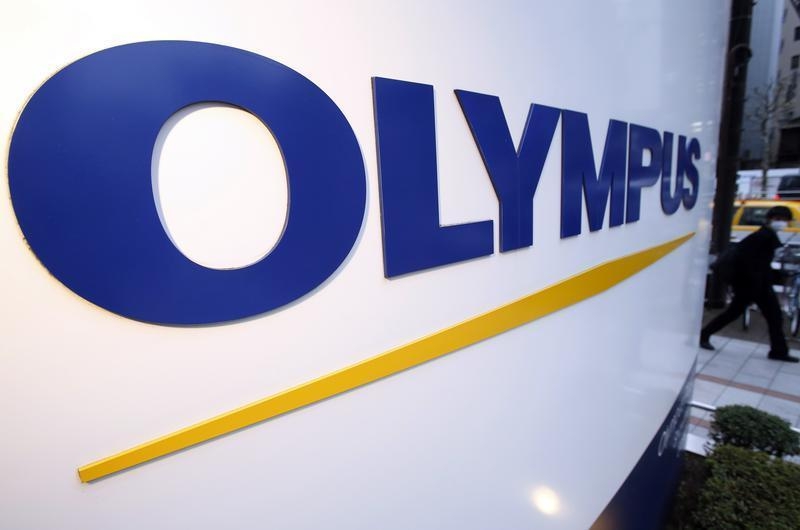 A man passes a logo of Japan's Olympus Corp outside the company showroom in Tokyo December 21, 2012. u00e2u20acu201d Reuters pic