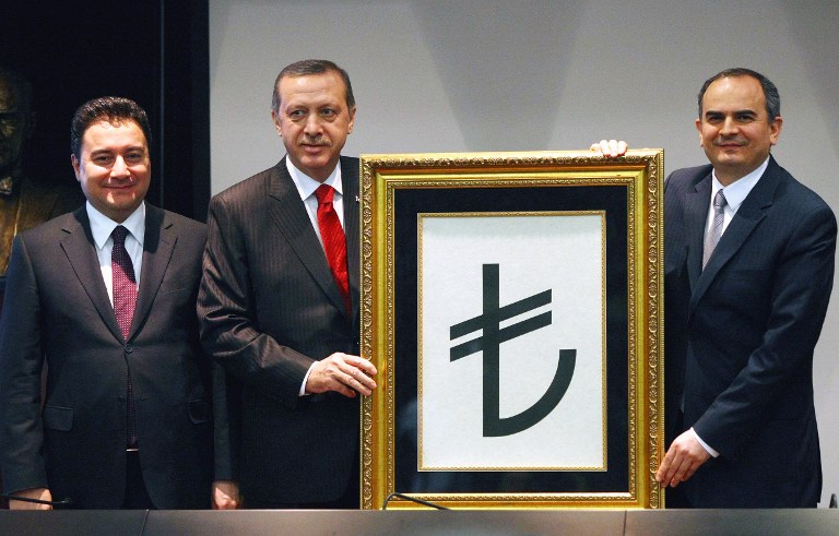 Turkish Prime Minister Recep Tayyip Erdogan (centre), his deputy Ali Babacan (right) and Central Bank Governor Erdem Basci, presents the new symbol (C) for the national currency, the Turkish lira, during a ceremony in Ankara, on March 1, 2012. u00e2u20acu201d AFP pic