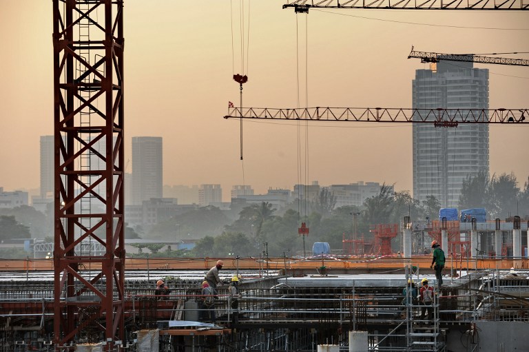 In this photograph taken on June 22, 2013, labourers work on a building construction site in Singapore. u00e2u20acu201d AFP pic