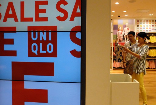 Customers check products at the Uniqlo casual fashion store in Tokyo on July 11, 2013. u00e2u20acu201d AFP pic