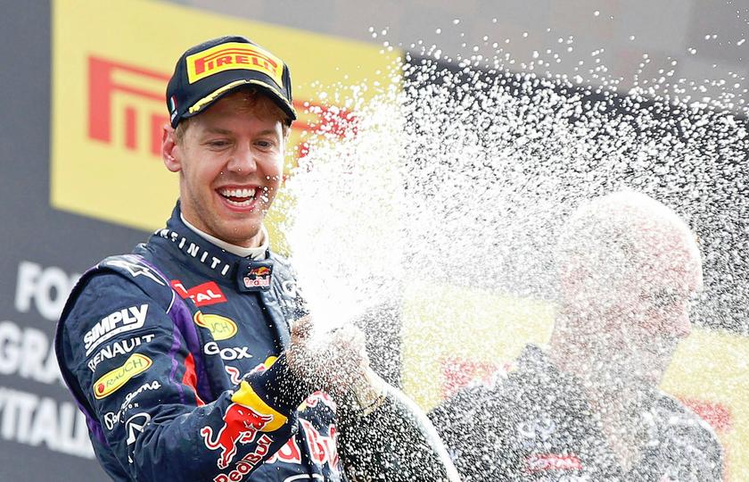 Red Bull Formula One driver Sebastian Vettel of Germany sprays champagne on the podium after winning the Italian F1 Grand Prix at the Monza circuit September 8, 2013. u00e2u20acu201d Reuters pic