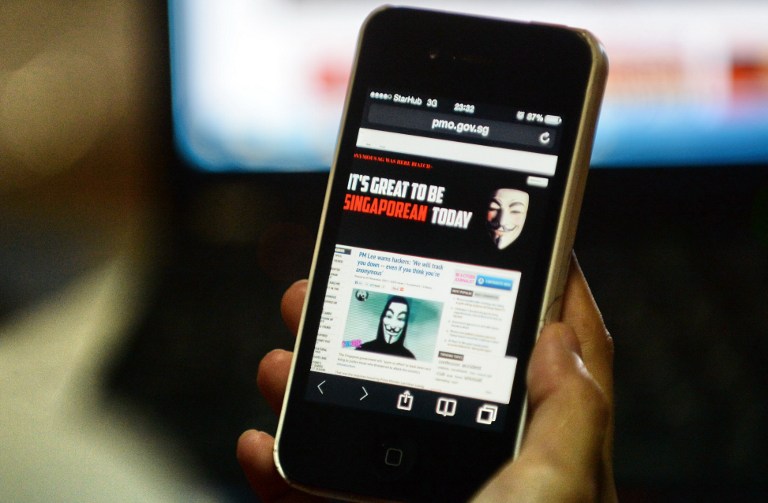 Activist hacker group Anonymous is seen through the internet government website of Singapore Prime Minister Office circulated online on a smartphone in Singapore on November 7, 2013. u00e2u20acu201d AFP pic