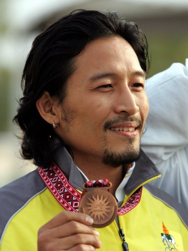Jakkrit Panichpatikum of Thailand shows his bronze medal he won in the Men's Shooting 25m Centre Fire Pistol final at the 15th Asian Games in Doha 08 December 2006. u00e2u20acu201d AFP pic